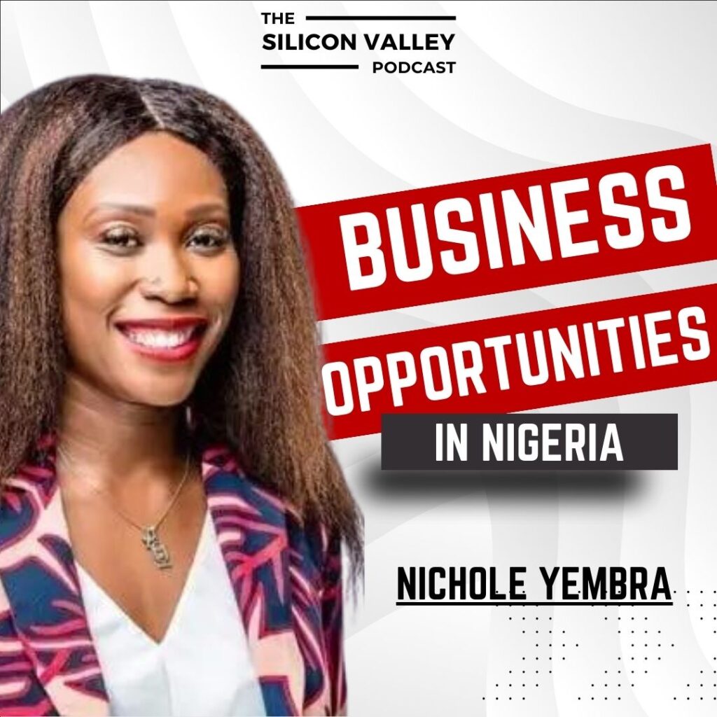 african female with big hair and smile with pink printed blazer and white shirt